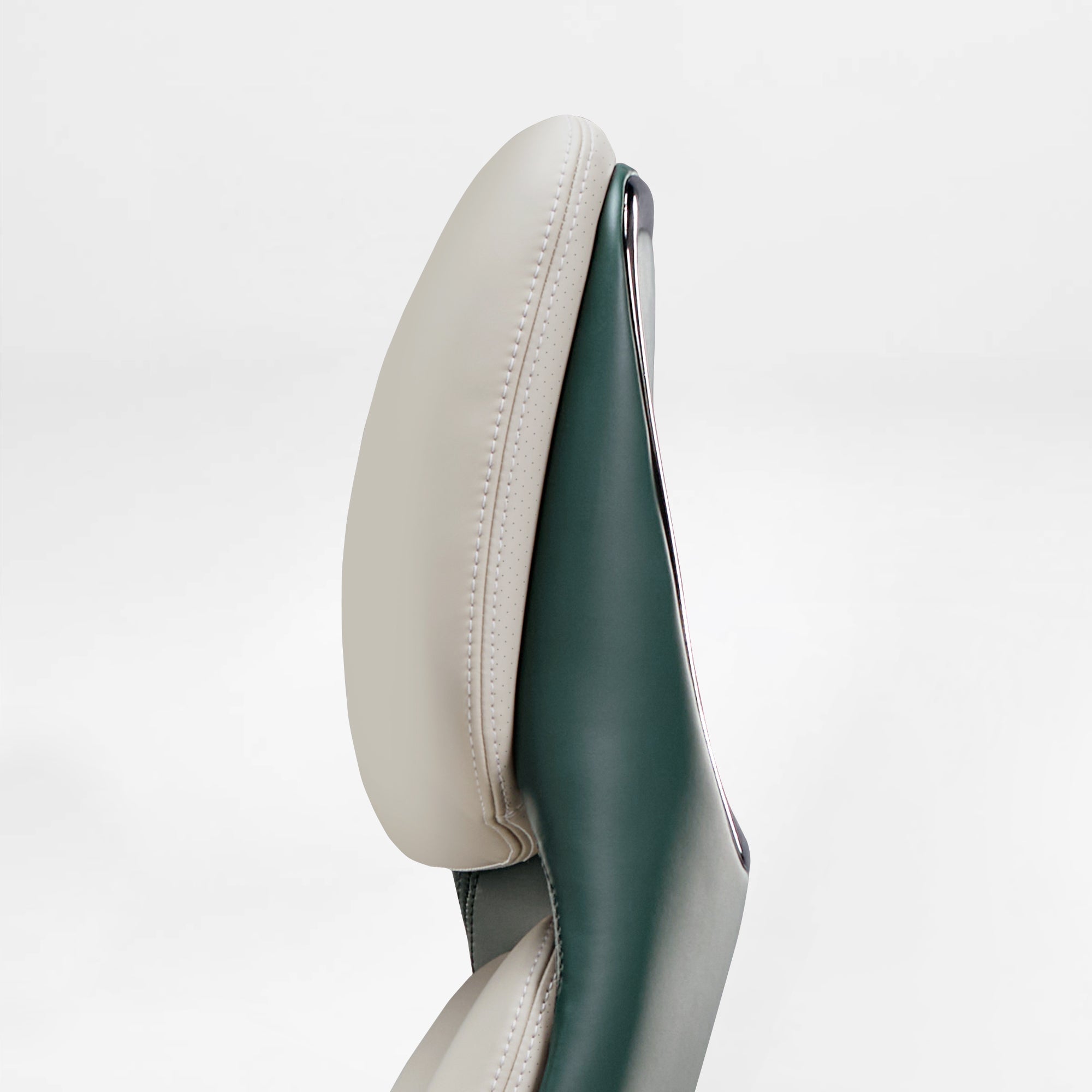 Eureka Ergonomic Serene executive chair headrest detail: cream perforated Napa leather and green smooth leather with contrast stitching.