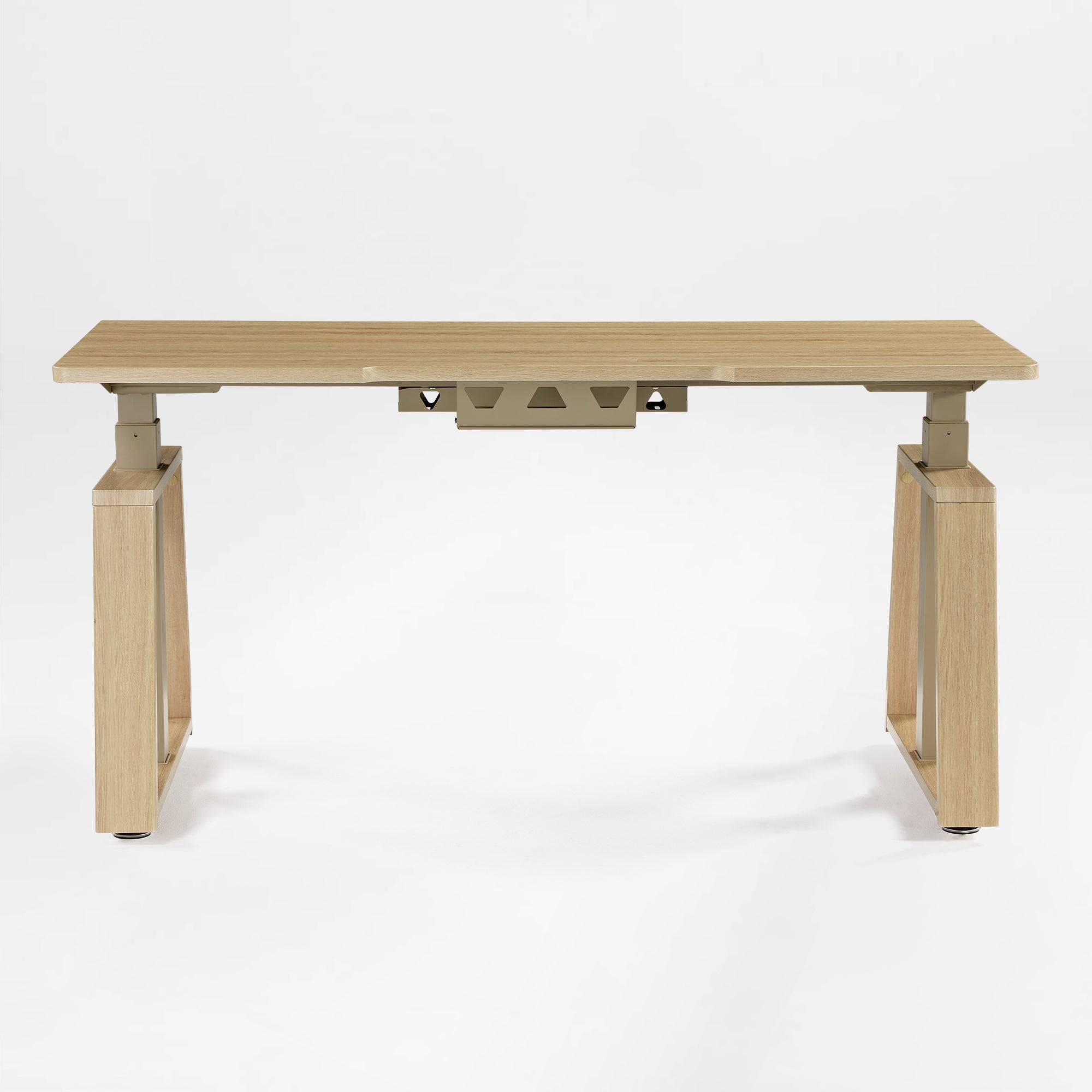 Eureka Ergonomic Ark Lite standing desk with light woodgrain MDF top, beige trapezoidal legs, and integrated cable management tray.