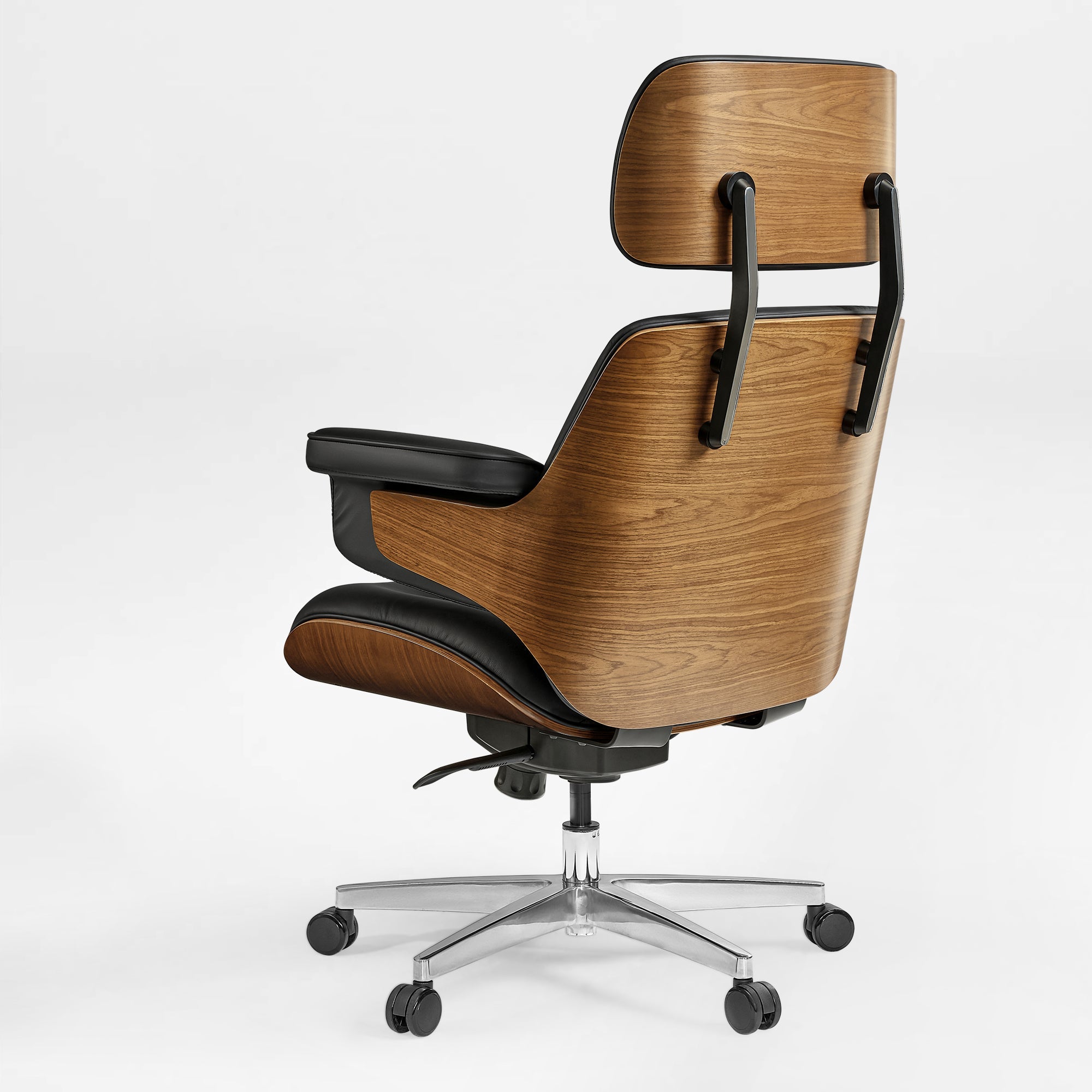 Eureka Ergonomic Mathias executive office chair with curved wood veneer shell and black leather upholstery on a silver five-wheel base.