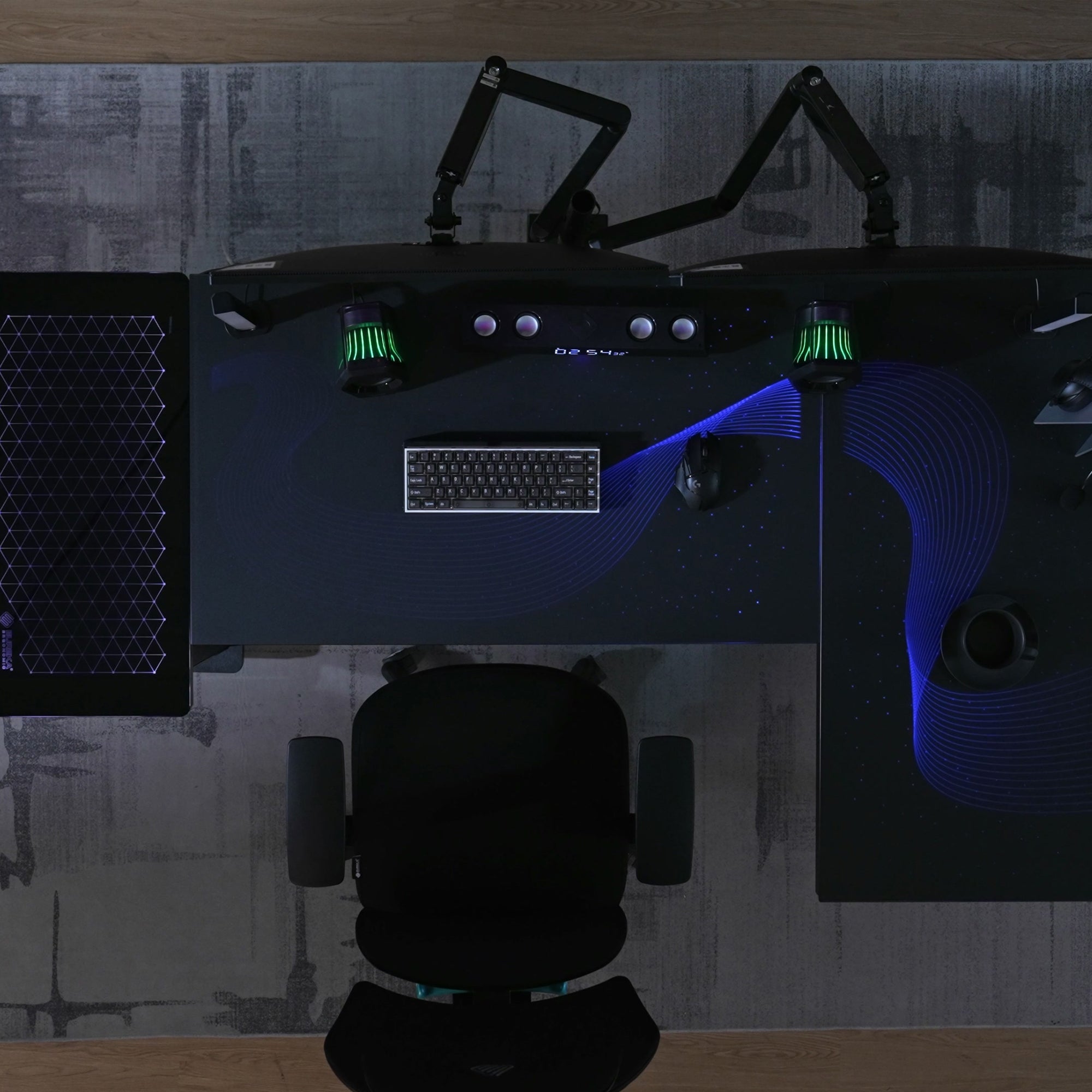 Eureka Ergonomic GTG L-shaped desk with dual monitors, keyboard, mouse, and RGB wave lighting.