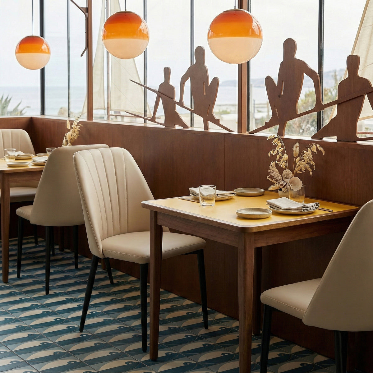Eureka Ergonomic Chester off-white chairs at a seaside restaurant table